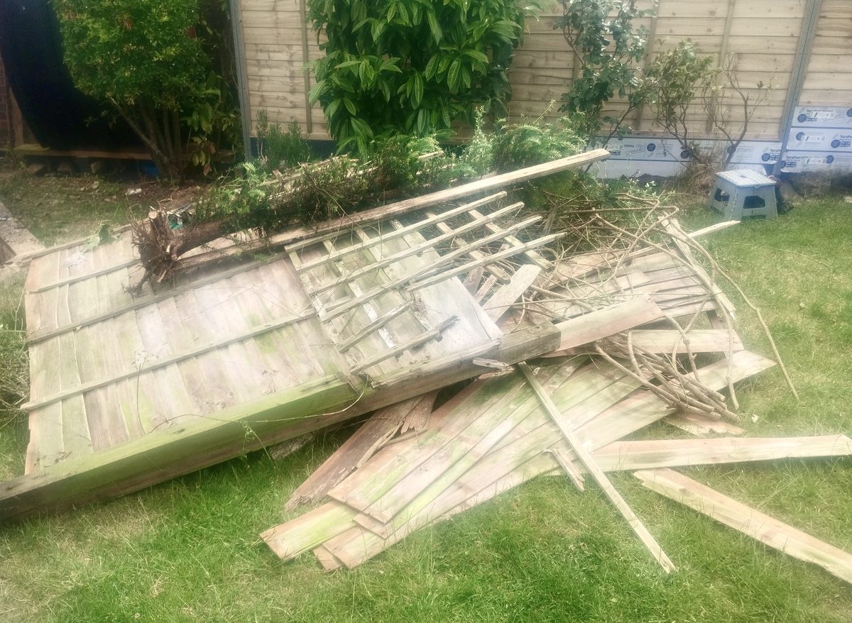 Broken collapsed wooden fence before replacement