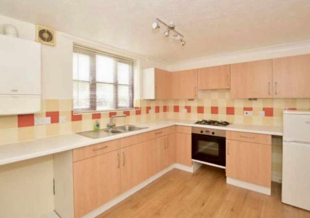 Kitchen before renovation with yellow oak cabinets